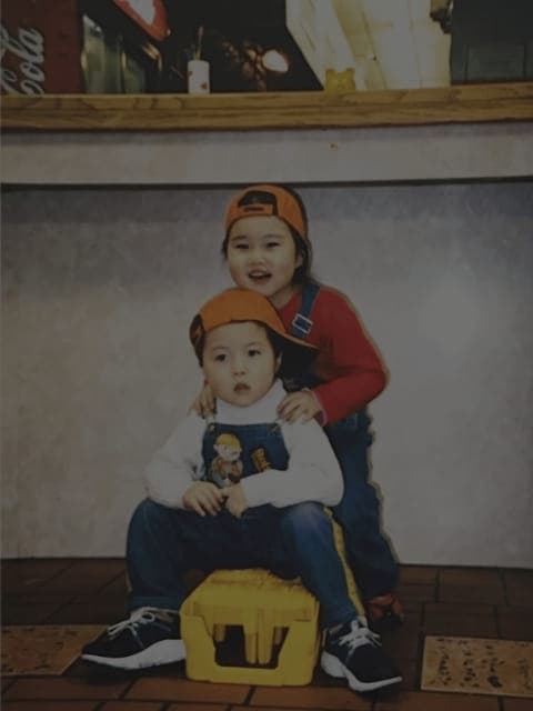 The owners' children sitting together wearing matching hats