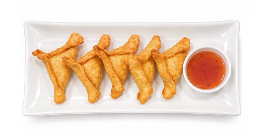 Triangle-shaped crab rangoon on a plate